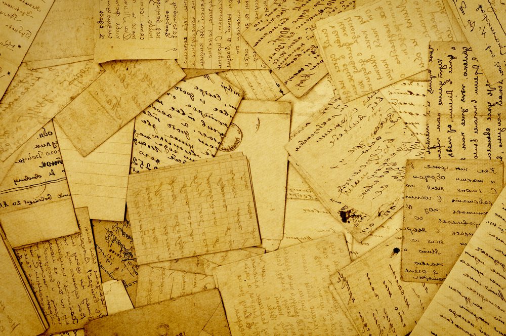 yellow papers covered with handwritten script